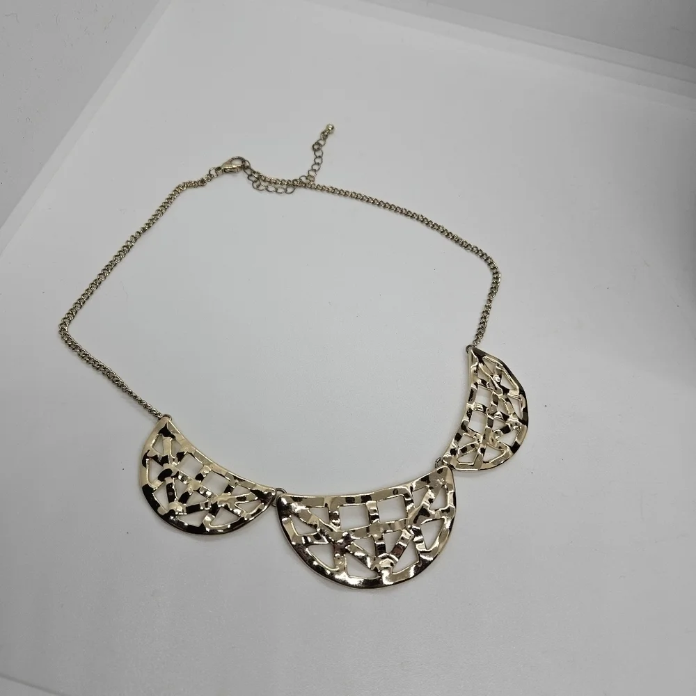 gold tone articulated crescent bib necklace